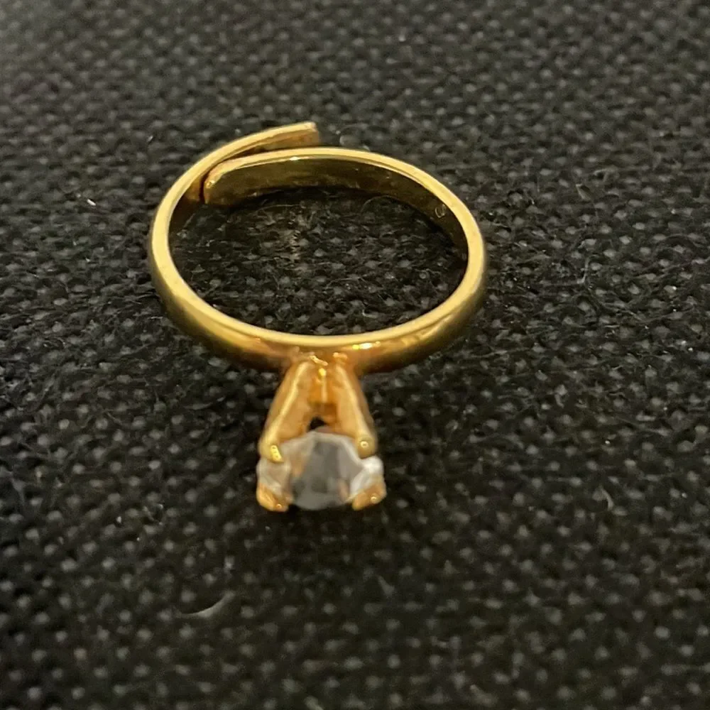 Adjustable band ring with a white gem